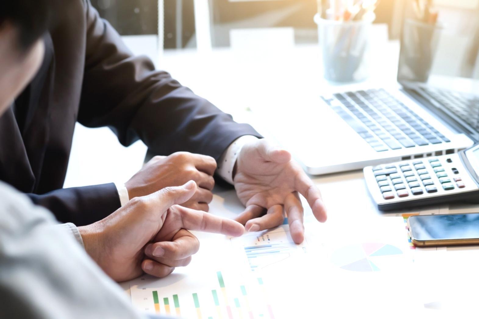 Strategic planning session with financial documents and analysis tools